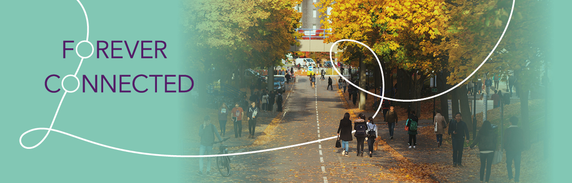 An autumnal view of campus with students walking 