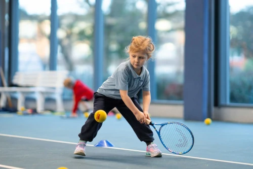 A child plays tennis